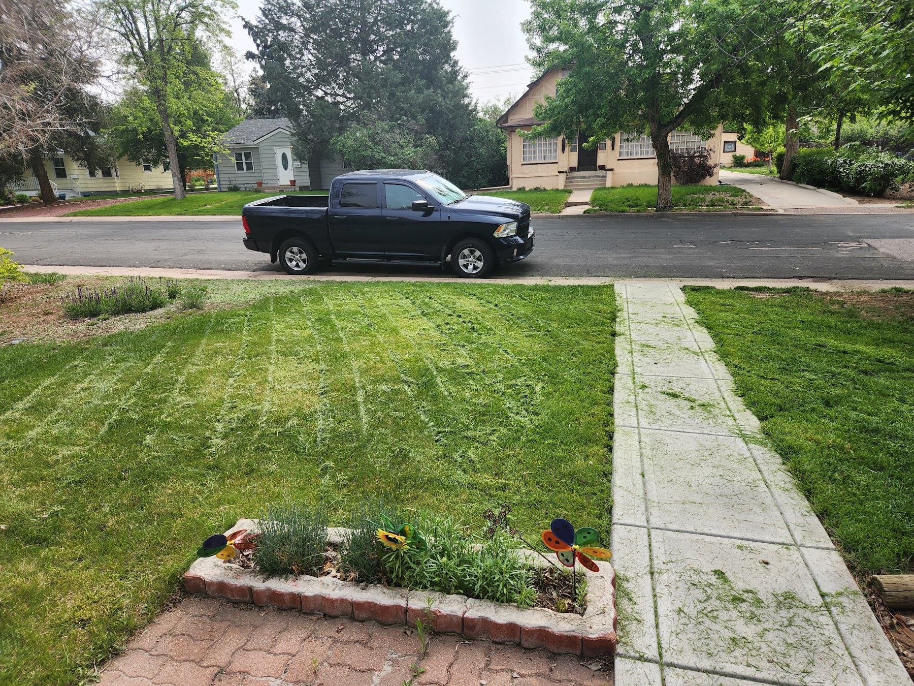 The shop truck at the curb for an equipment pickup in a Littleton neighborhood